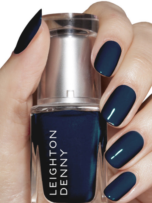 Jet Setter deep navy nail colour on nails holding 12ml bottle