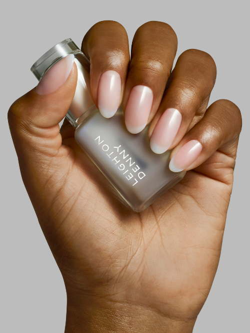 Luminosity nail brightener on nails to help them look brighter and fresher.