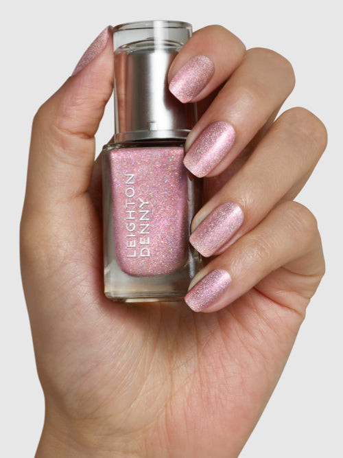 Naughty But Nice rose nail colour with holographic glitter on nails with bottle