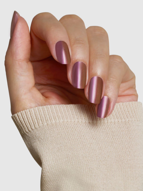 Naughty List nail colour on nails - a rose gold metallic with a hint of plum.