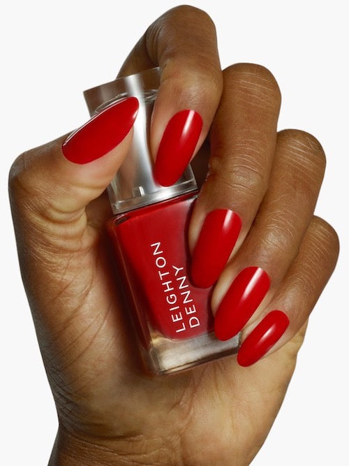 Provocative pillar box red nail colour on nails darker skin tone